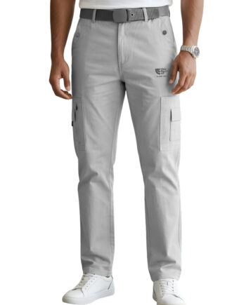 A man wearing light grey, slim-fit cargo pants styled with a white t-shirt and white sneakers. The pants feature a zippered security pocket on the right thigh, a flap cargo pocket on the left, and a grey textured belt. The image is set against a plain white background for a clean, professional studio look.